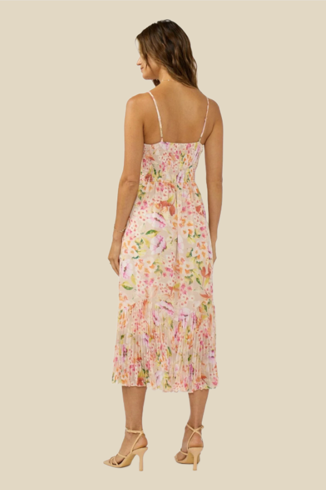 Woman wearing a floral dress on a beige background